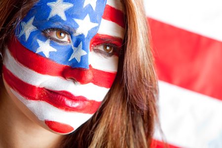 Patriotic American woman with the USA flag painted on her face