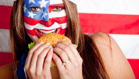 American woman eating a hamburger Ã?Â?Ã?Â� fast food concepts