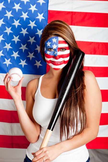 Female American baseball fan with the USA flag painted on her face
