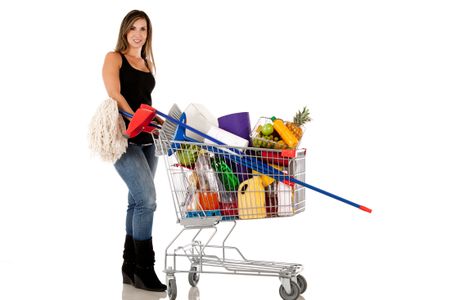Woman with a shopping cart buying groceries - isolated over white