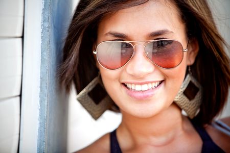 Portrait of a beautiful woman wearing sunglasses outdoors