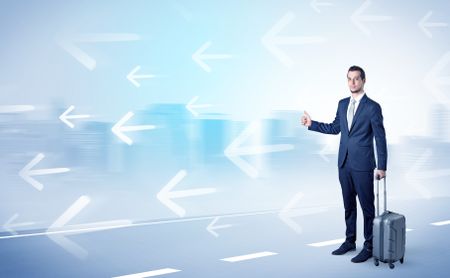 Young businessman hitchhiking near the city with arrows around concept