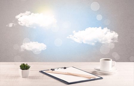Close up of business office desk concept with clouds, blue sky and sunshine