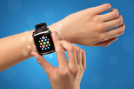 Naked female hand with smartwatch and with application icons on it