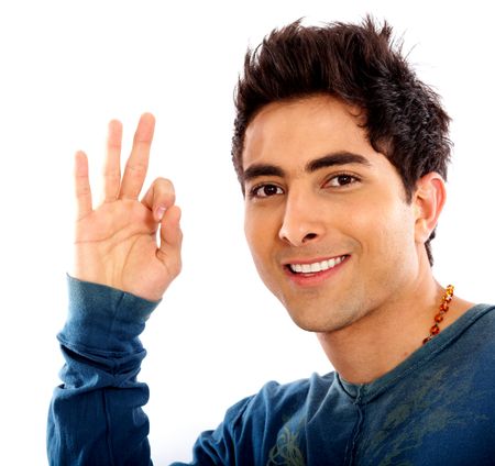 casual man smiling doing the ok sign over a white background