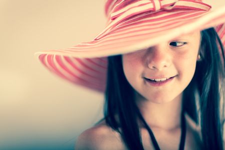 Portrait of a beautiful girl wearing a hat and smiling