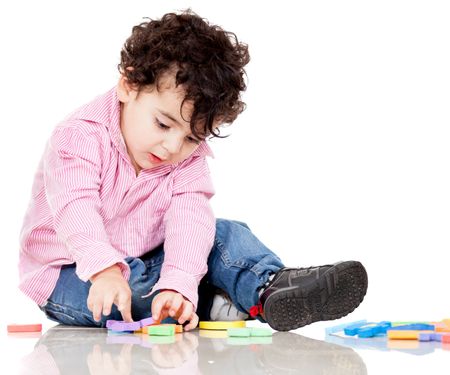 Boy playing with letters - isolated over a white background