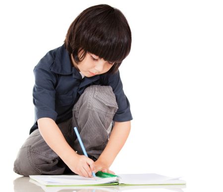 Boy coloring a book - isolated over a white background