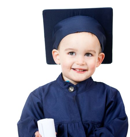 Little boy graduating in a blue gown - isolated over white