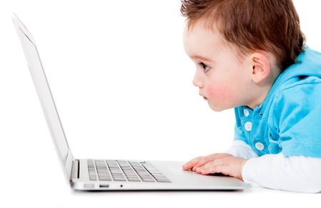 Little boy looking at a laptop computer - isolated over white