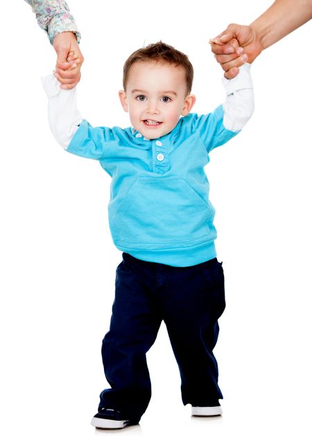 Little boy learning how to walk - isolated over a white background