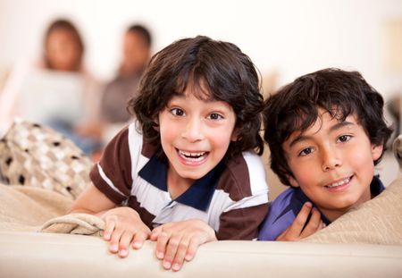 Happy kids having fun at home and smiling