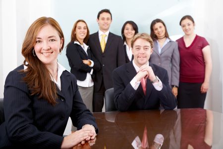 business woman smiling leading a team during an office meeting