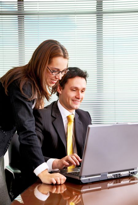 business people in an office on a laptop computer