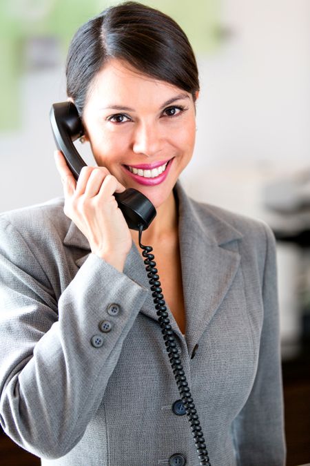 Successful businesswoman talking on the phone at the office