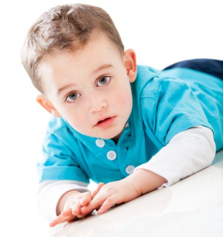 Boy lying on the floor - isolated over a white background