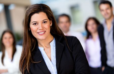 Successful woman at the office leading a business group