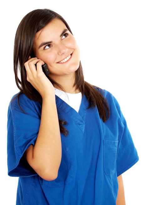 friendly woman doctor smiling on the phone isolated over a white background
