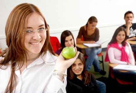 teacher and students smiling in a classroom