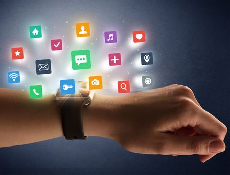 Naked female hand with smartwatch and  application labels around and dark background