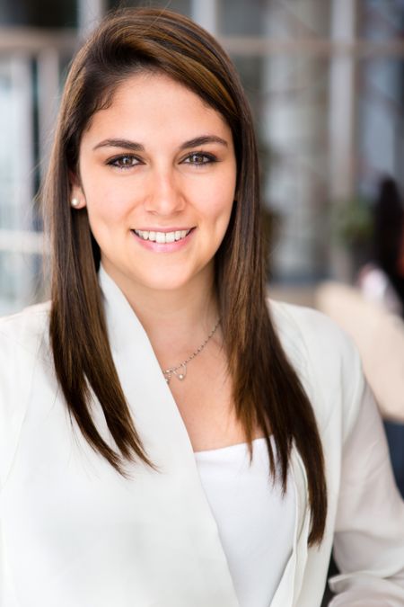 friendly-business-woman-office-smiling-103977014 Friendly business woman at the office smiling