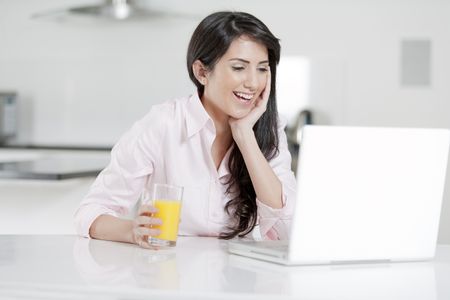 Girl using laptop at home to chat with friends