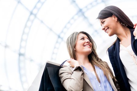 happy-women-shopping-smiling-mall-104070419 Happy women shopping and smiling at the mall