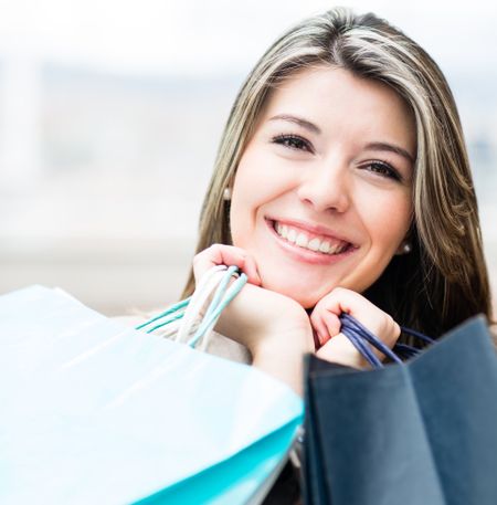 Portrait of a happy woman shopping and holding bags