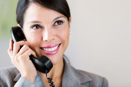 Successful businesswoman talking on the phone and smiling