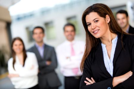 Female business leader with her team at the background