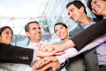 Successful business group with hands together and smiling