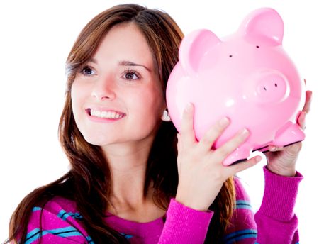 Woman holding a piggybank and smiling - isolated over white