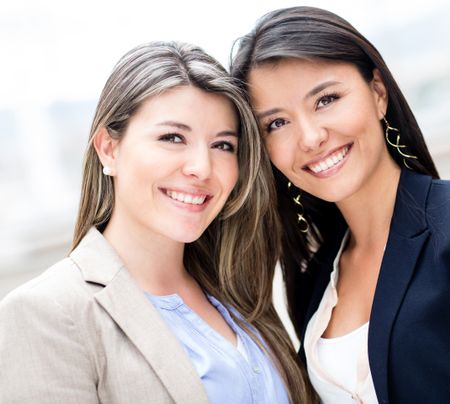 Casual business women looking happy and smiling