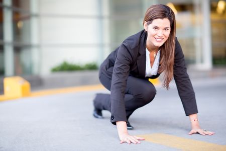 Competitive business woman in a racing position