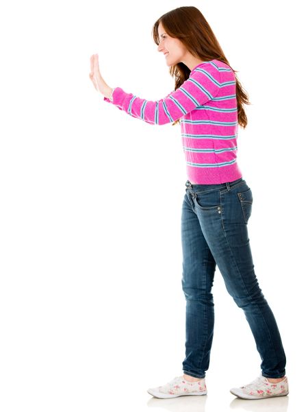Woman pushing an imaginary object - isolated over a white background