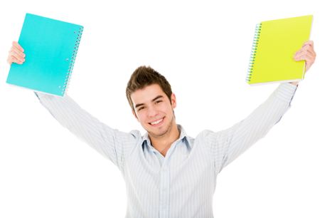 Happy male student with arms up holding notebooks - isolated