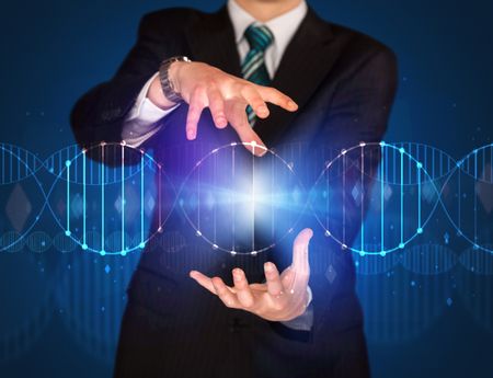 Businessman with DNA concept in his hands 