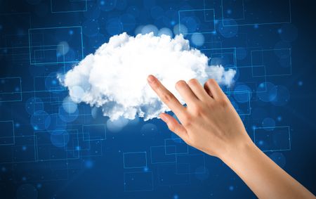 Female hand touching cloud with blue background 
