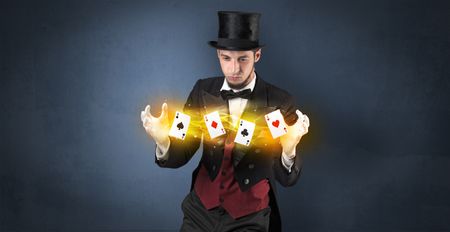 Illusionist in tails bandy play cards between his two hands