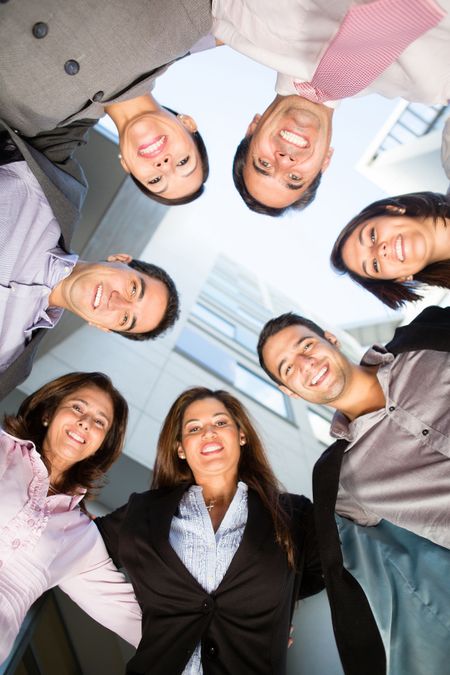 Group of business people in a circle smiling