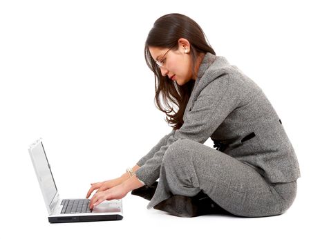 Business woman typing on a laptop computer - isolated over a white background