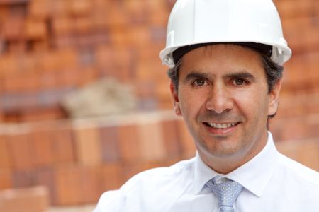 male engineer at a construction site smiling