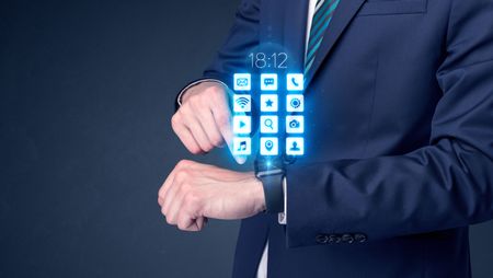 Businessman wearing smartwatch with application icons.