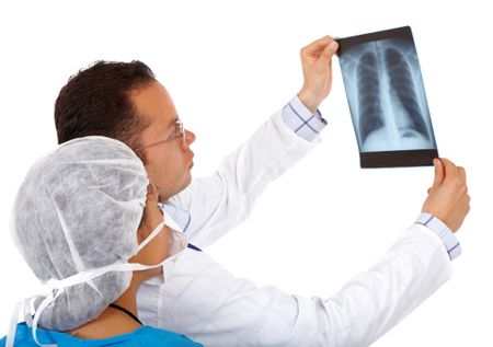 doctors checking a chest xray isolated over a white background