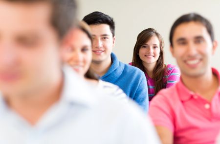 Group of young people smiling in a classroom