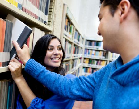 Couple of students at the library looking for a book