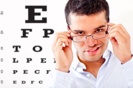 Man taking an eye exam and wearing glasses