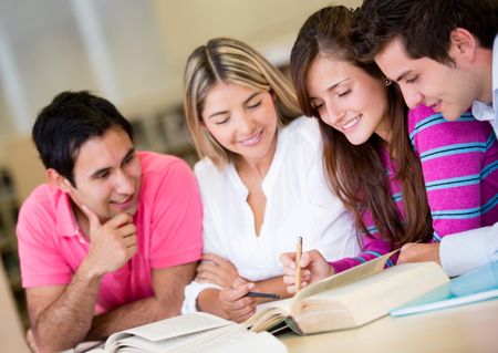 Group of students studying together for an exam an the library