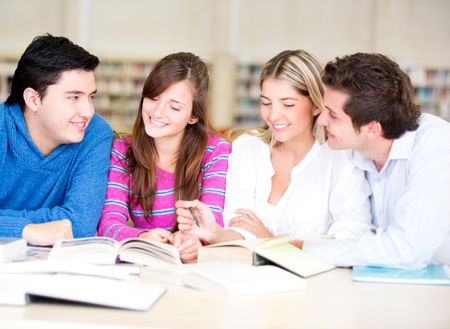 Group of students sitting at the library and talking