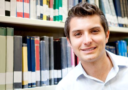 Portrait of a young man at the library smiling